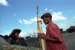 Bushmen pack up bows and arrows while preparing to go home